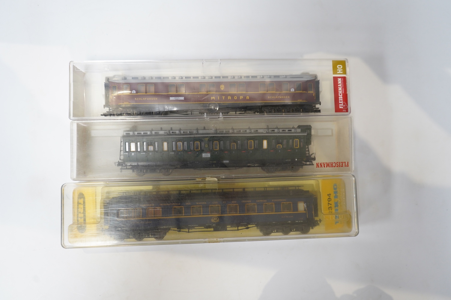 Twenty-four HO gauge model railway by Lima, Trix, Fleischmann, etc. including a German DB 4-6-2 tender locomotive, 10 001, fourteen Continental outline bogie coaches, 4-wheel coaches, and freight wagons. Condition - fair